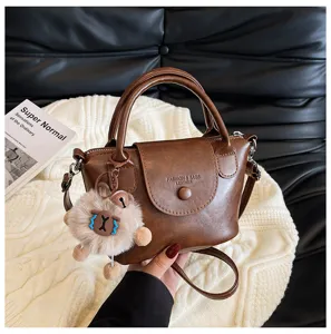 Retro brown PU leather handbag for women, chic shoulder crossbody bag with cute plush pendant