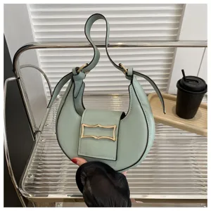 Light green crescent underarm shoulder bag for women, trendy niche bag with metal buckle.