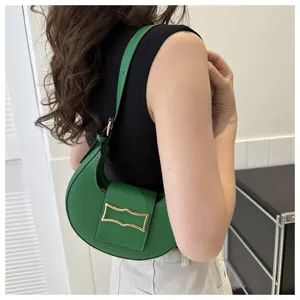 Green crescent shoulder bag for women, stylish underarm hobo bag with metal buckle design.