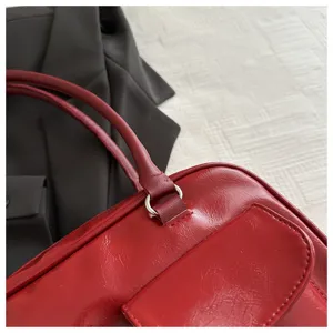 Red patent leather retro boston shoulder bag detail, stylish women handbag, chic tote purse.