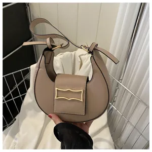 Detailed view of trendy crescent shoulder bag, stylish PU leather crossbody bag accessory.