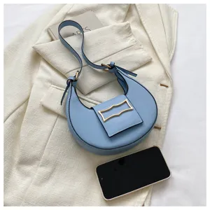 Light blue crescent shoulder bag for women, stylish underarm hobo bag with metal buckle.