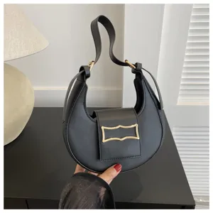 Close-up detail of the black crescent underarm bag, featuring sleek PU leather and metal buckle.