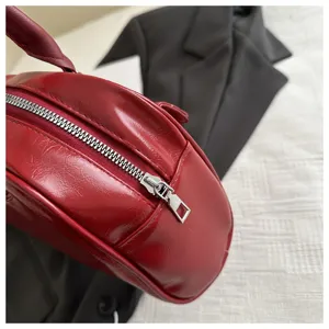 Red patent leather bowling bag detail close-up, stylish retro design, premium texture and zipper.