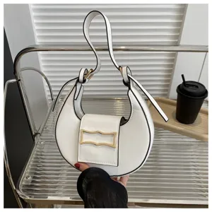 White crescent shoulder bag detail, stylish PU leather underarm handbag with gold buckle.