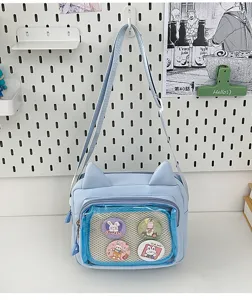 Cute blue cat ear canvas messenger bag with transparent ita pocket and sweet pins for girls.