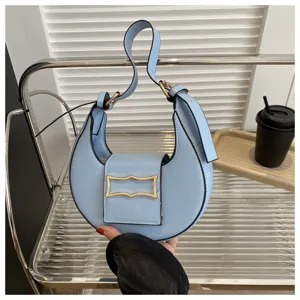 Light blue crescent hobo shoulder bag, minimalist chic underarm purse with metal buckle.