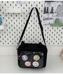 Detail view of Japanese style canvas shoulder bag with clear front pocket and cute pins.