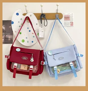 Cute preppy style canvas messenger bag with clear front pocket, large capacity student bag.