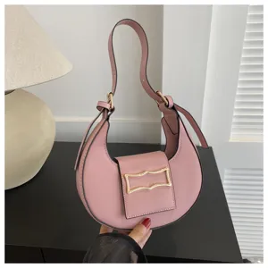 Pink crescent hobo bag detail shot, PU leather single shoulder strap and front buckle design.