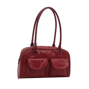 Red glossy bowling shoulder handbag detail view, showing dual front pockets and long handles.