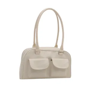 Detailed shot of beige retro shoulder handbag showcasing front double pockets and dual straps.