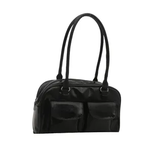 Black patent leather shoulder bag detail, stylish vintage bowling style handbag with pockets.