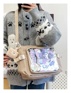 College style large capacity messenger bag with clear window and cute doll pendant for daily use.