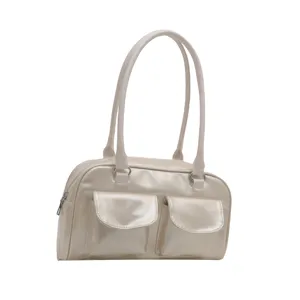 Close-up detail of the vintage metallic shoulder bag featuring front pockets and dual straps.