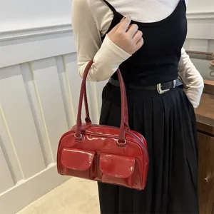 Red patent leather vintage bowling shoulder bag for women, chic retro Boston handbag.