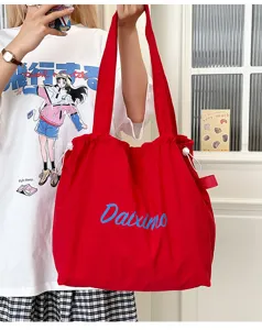 Red canvas drawstring tote bag, large capacity casual shoulder bag for students daily commute.