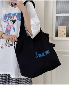 Black canvas tote bag for women, casual daily commute shoulder bag with drawstring.