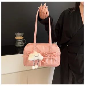 Pink patent leather bowling bag with bow pockets and fluffy cloud charm for women.