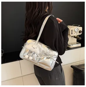 Silver bowling shoulder bag detail featuring a cute plush cloud charm and sweet bow decor.