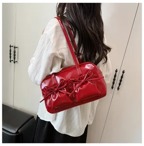 Red patent leather bow shoulder bag for women, stylish underarm tote handbag for daily use.