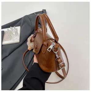 Retro brown top handle crossbody bag for women, stylish minimalist design with metal zipper details.