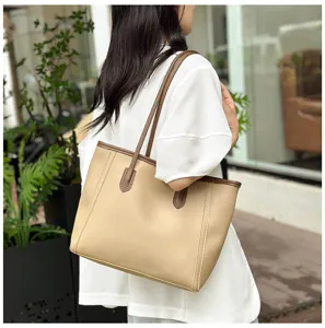 Detail shot showing the stylish beige tote bag worn on the shoulder, perfect for daily commuting.