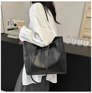 Detailed view of the black leather tote bag, stylish large capacity shoulder bag for women.