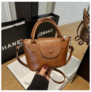 Retro brown leather top-handle crossbody bag for women, chic vintage daily shoulder handbag.