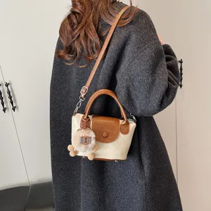 Stylish women contrast color shoulder bag retro top-handle crossbody bag with cute charm.