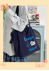 Detailed shot of casual navy blue canvas tote bag with cute dog embroidery and daily lifestyle outfit.