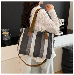 Stylish striped canvas tote bag for women, trendy commuter shoulder and crossbody bag.