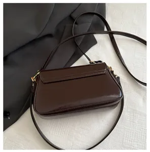 Elegant dark brown patent leather shoulder bag with sleek metallic hardware for women.