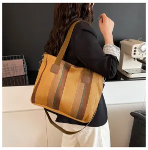 Stylish striped canvas tote bag for women, casual commuter shoulder and crossbody bag.