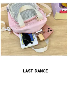 Pink nylon ita bag detail view, transparent mesh pocket, casual crossbody handbag for students.