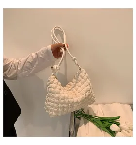 Detailed view of the white crinkled cloud shoulder bag, showing soft texture and fine strap.