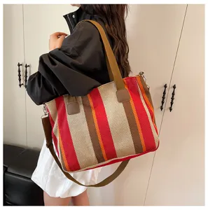 Detail view of the stylish striped canvas tote bag, featuring spacious capacity and straps.