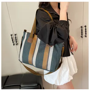 Stylish striped canvas tote bag for women, commuter shoulder and crossbody design.