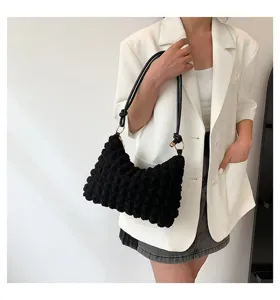 Black bubble textured cloud shoulder bag worn by model, trendy Korean style underarm bag.
