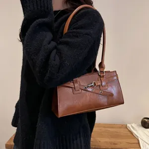 Retro brown PU leather shoulder bag for women, chic vintage underarm bag for daily fashion wear.
