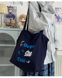 Detail shot of casual dark blue canvas tote bag with cute dog graphic print and large capacity.
