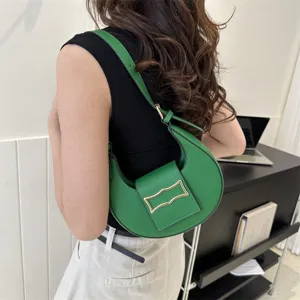 Green crescent shoulder bag for women, stylish underarm hobo bag with unique metal buckle.