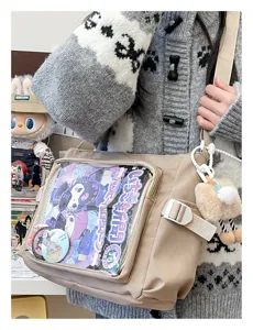 Detailed view of beige ita bag with transparent window, perfect for anime pins and merch display.