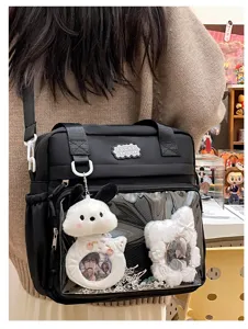 Japanese style cute student ita bag with clear window and plush doll charms in black.