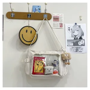 College style canvas messenger bag with clear ita pocket for badges and plush toys. Large capacity.
