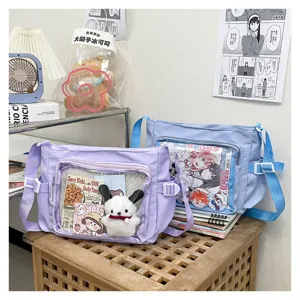 Detail shot of college style transparent ita messenger bag with cute doll display window.