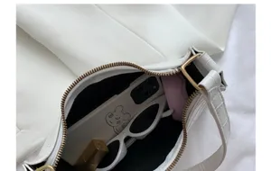 White stone pattern shoulder bag detail, chic underarm hobo bag with gold hardware inside.