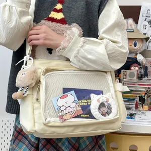 Collegiate style large capacity messenger bag with clear ita window for cute pins and badges.