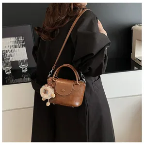 Korean retro shoulder bag for women, versatile PU leather handbag with cute plush pendant.