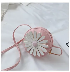 Detailed view of the cute pink round children crossbody bag with white 3D daisy flower design.